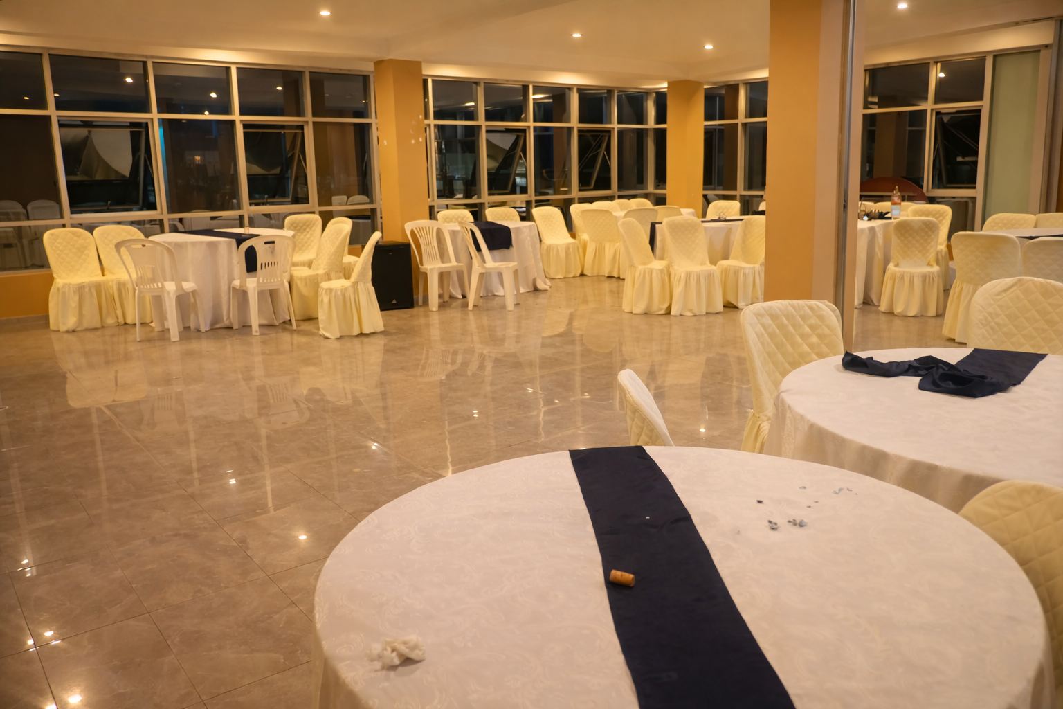 Elegant venue exterior at night with illuminated entrance and landscaping